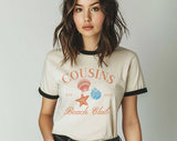 "Cousins Beach Club The Summer I Turned Pretty" design on a natural ringer t-shirt with black contrast trim