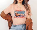 "Hotter Than Hoochie Coochie" design on a peach unisex t-shirt