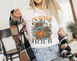 "The Midnight Hour Retro Pumpkin" design on a white unisex t-shirt
