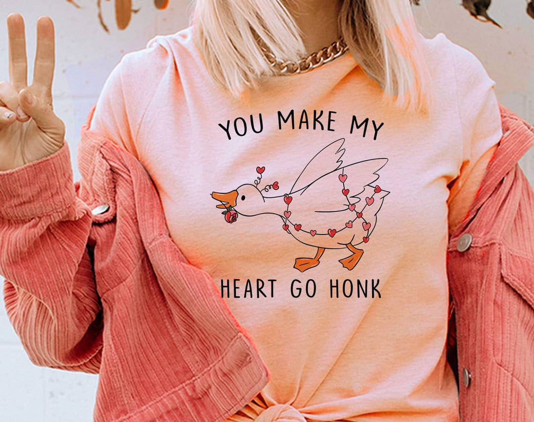"You Make My Heart Go Honk" design on a peach unisex t-shirt