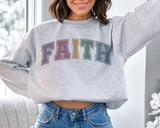 "Faith Easter Pastel" design on an ash gray unisex crewneck sweatshirt