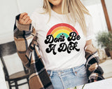 "Don't Be A D*ck Rainbow" design on a white unisex t-shirt