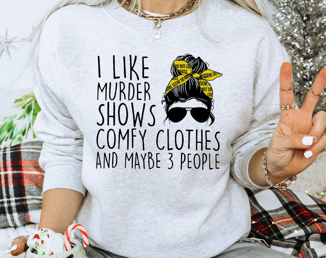 "I Like Murder Shows" design on an ash gray unisex crewneck sweatshirt
