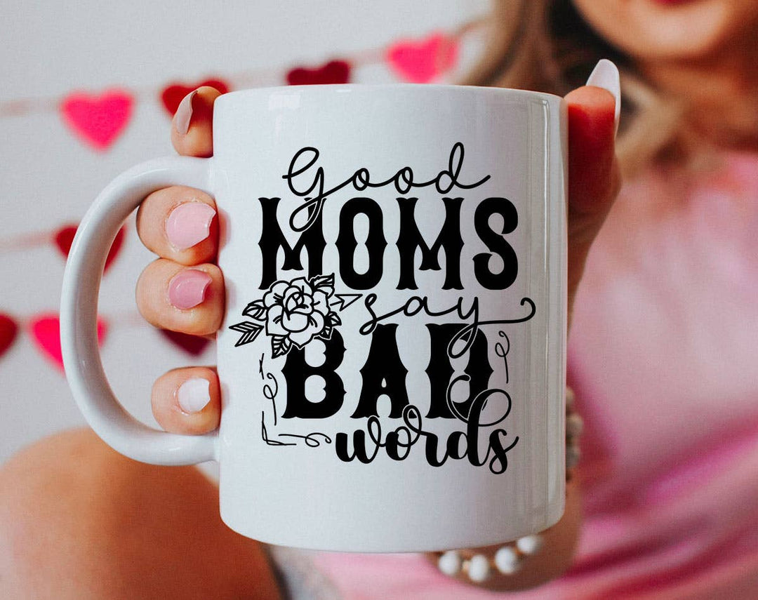"Good Moms Say Bad Words" design on a white ceramic coffee mug