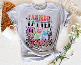 "Tanned Tatted Tipsy" design on a heather gray unisex t-shirt