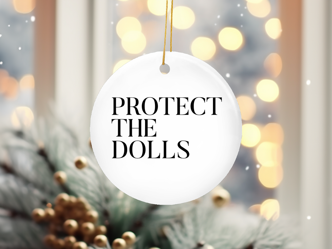 "Protect The Dolls Trans Rights" design on a 2.5 inch round ceramic Christmas ornament