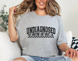 "Undiagnosed, But Something Ain't Right" design on a heather gray unisex t-shirt