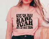 "Give 'Em That Hawk Tuah" design on a peach unisex t-shirt