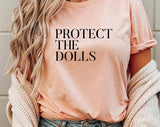 "Protect The Dolls" design on a peach unisex t-shirt