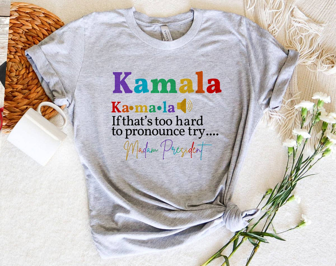"Kamala Hard To Pronounce, Try Madam President" design on a heather gray unisex t-shirt