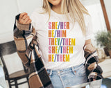 "She Her He Him Pronouns" design on a white unisex t-shirt