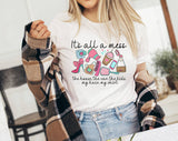 "It's All A Mess Mom" design on a white unisex t-shirt