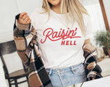 "Raisin' Hell" design on a white unisex t-shirt