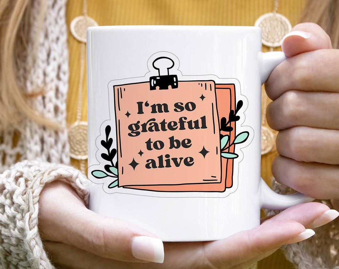 "I'm So Grateful To Be Alive" design on a white ceramic coffee mug