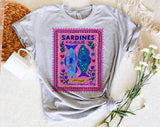 "Sardines Purple Stamp" design on a heather gray unisex t-shirt