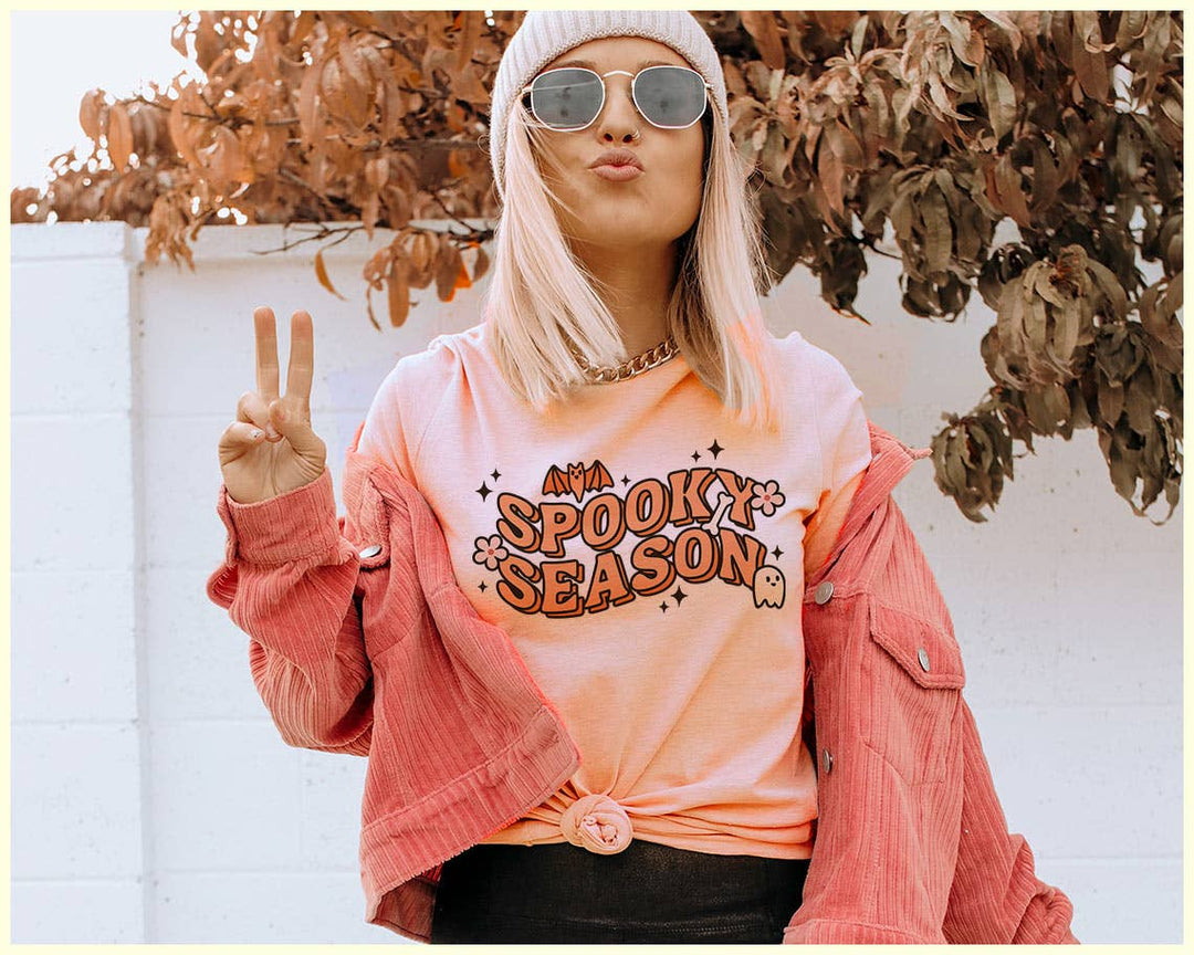 "Spooky Season Ghost" design on a peach unisex t-shirt