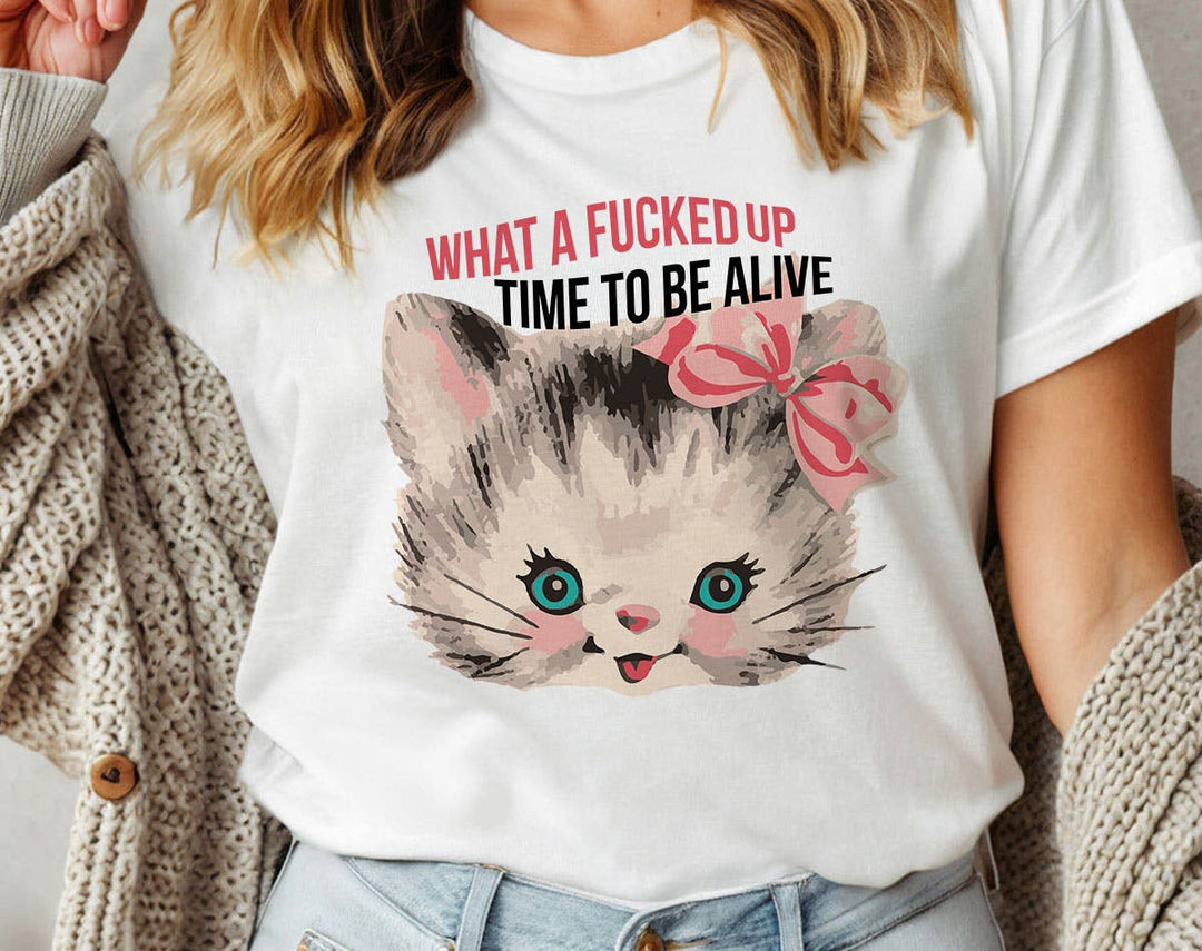 "What A F*cked Time To Be Alive Kitten" design on a white unisex t-shirt