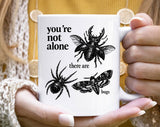 "You're Not Alone, There Are Bugs" design on a white ceramic coffee mug