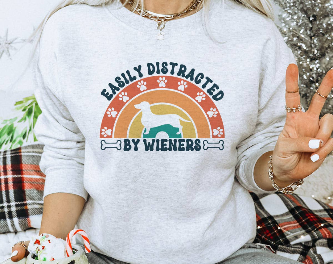 "Easily Distracted By Wieners" design on an ash gray unisex crewneck sweatshirt