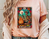 "The Happy Camper Tarot" design on a peach unisex t-shirt
