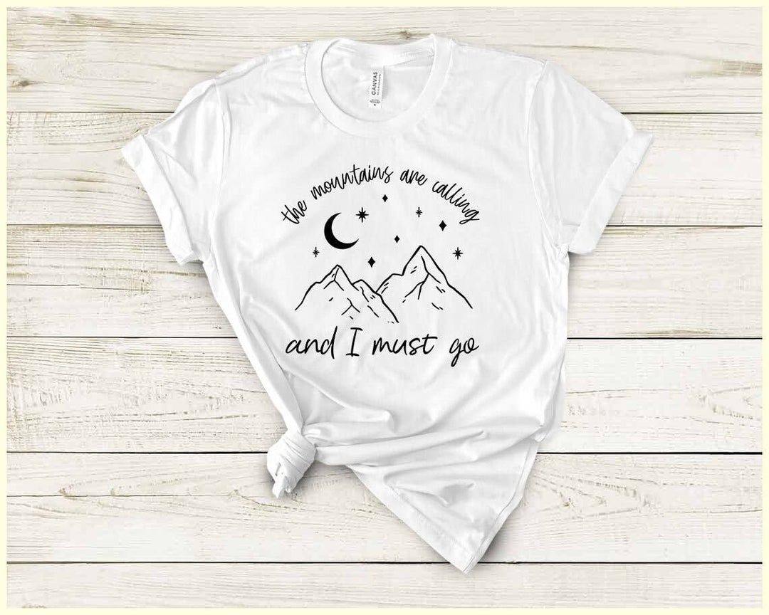 "The Mountains Are Calling" design on a white unisex t-shirt