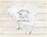 "The Mountains Are Calling" design on a white unisex t-shirt