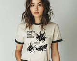 "You're Not Alone, There Are Bugs" design on a natural ringer t-shirt with black contrast trim