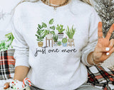 "Just One More Plant" design on an ash gray unisex crewneck sweatshirt