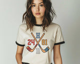 "Heated Rivalry 24 81 Hockey" design on a natural ringer t-shirt with black contrast trim