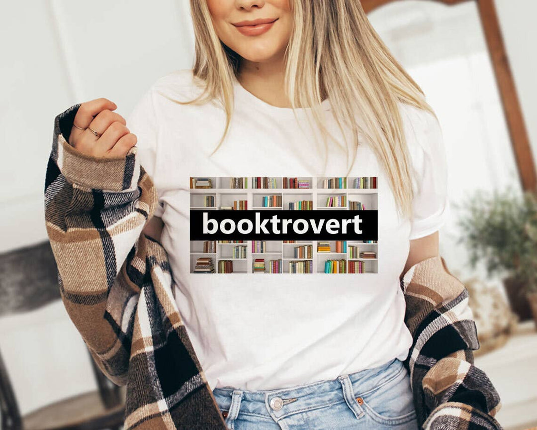 "Booktrovert Book Spines" design on a white unisex t-shirt