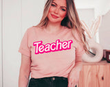 "Teacher Pink Logo" design on a peach unisex t-shirt