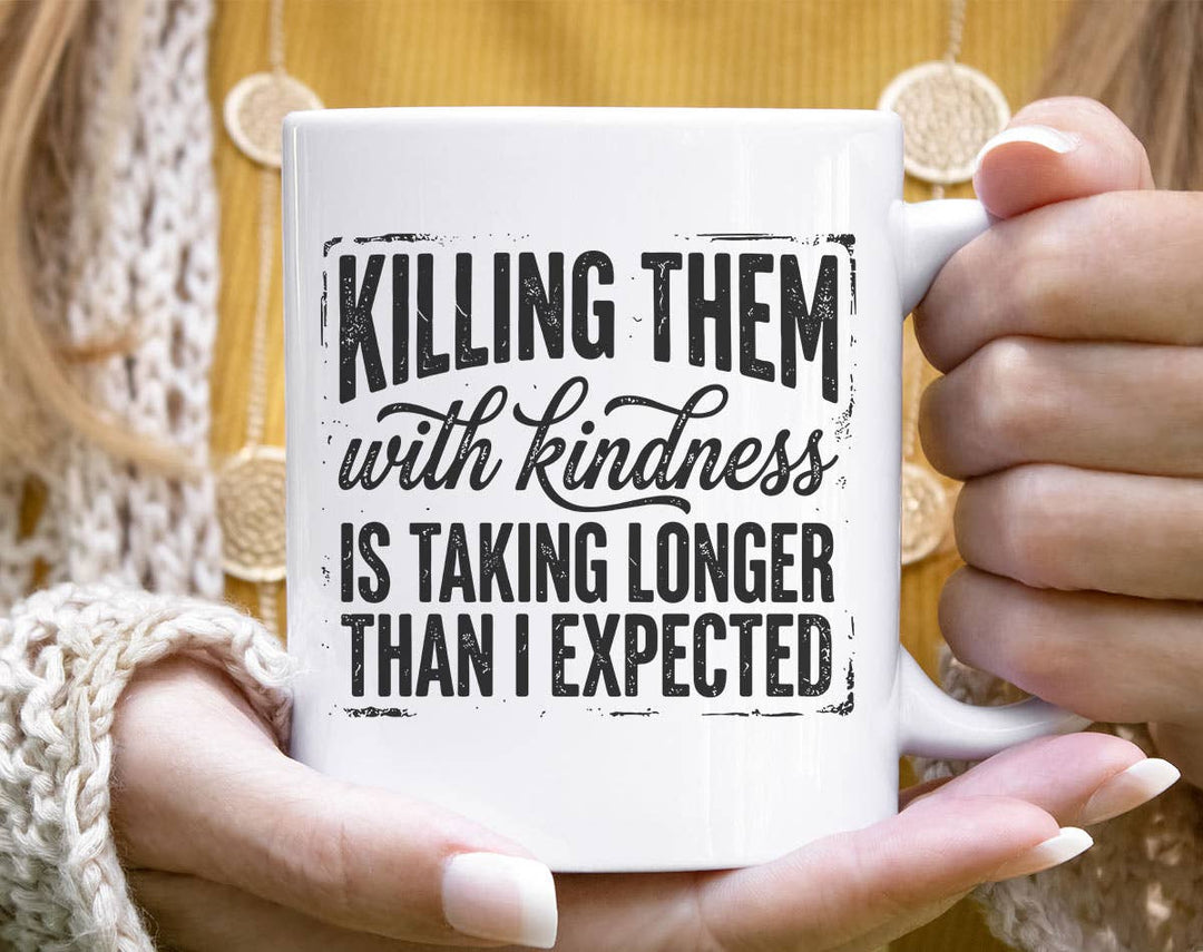"Killing Them With Kindness" design on a white ceramic coffee mug