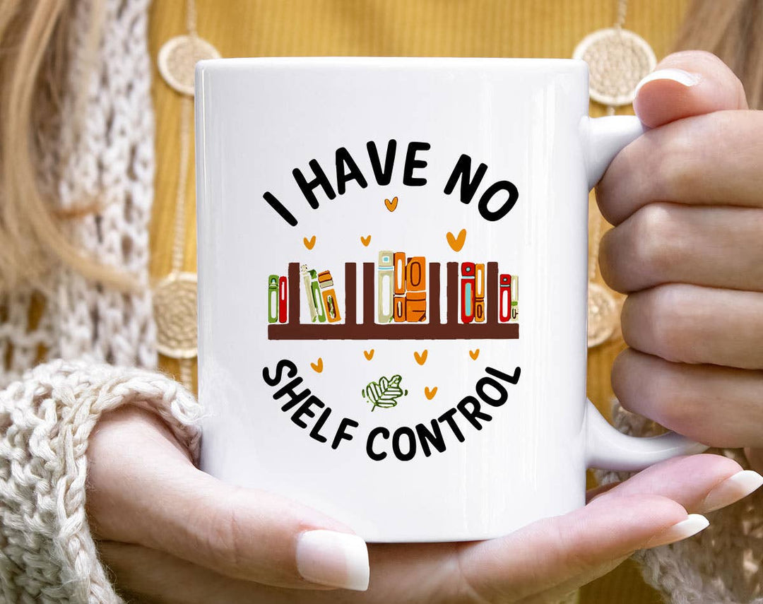 "I Have No Shelf Control" design on a white ceramic coffee mug