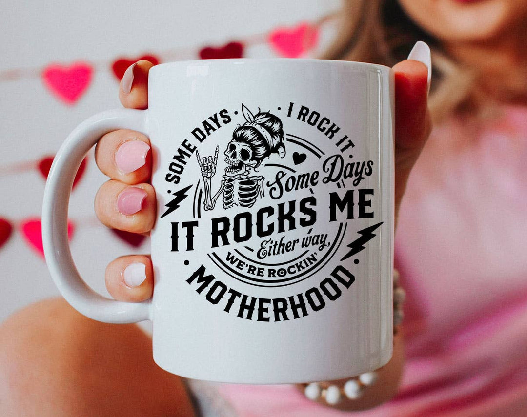 "Some Days I Rock It Motherhood" design on a white ceramic coffee mug