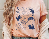 "Cats Floating In Space" design on a peach unisex t-shirt