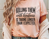 "Killing Them With Kindness" design on a peach unisex t-shirt