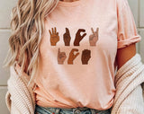 "F*ck ICE Sign Language" design on a peach unisex t-shirt