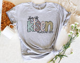 "He Is Risen Matthew 28:6" design on a heather gray unisex t-shirt