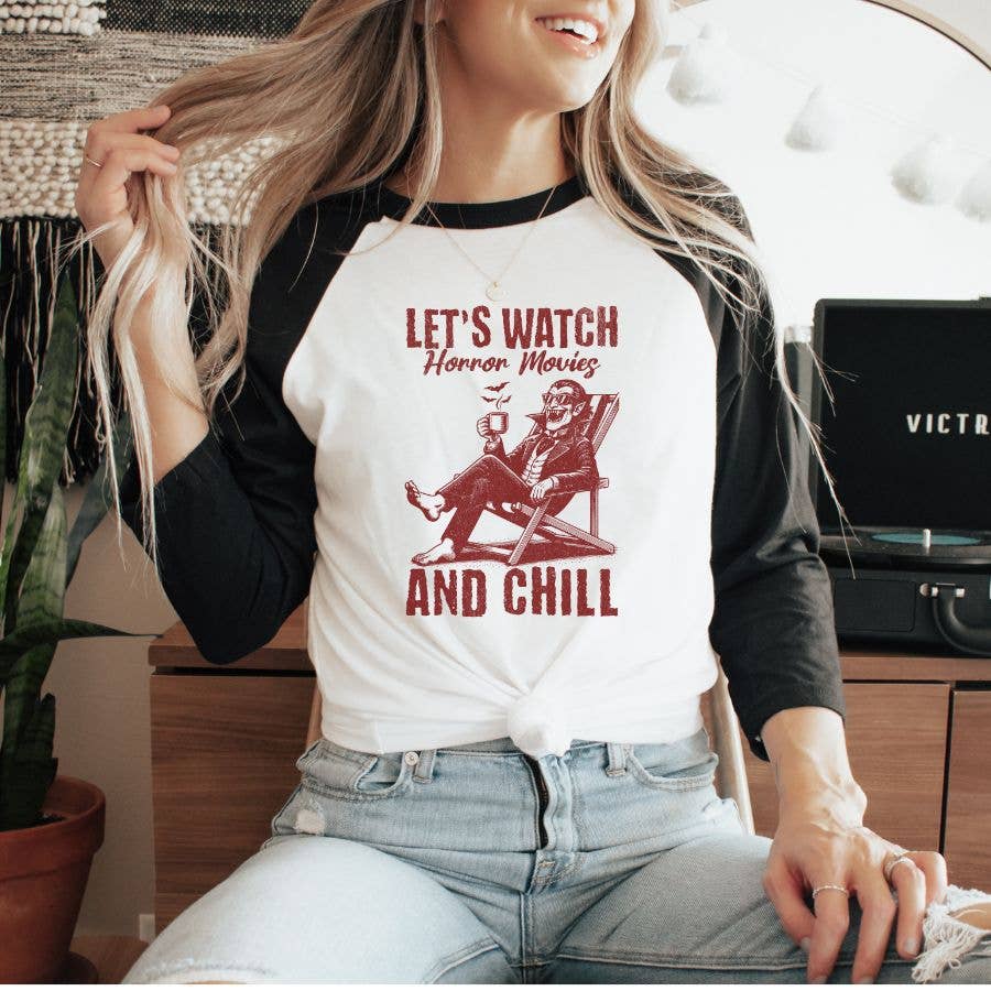 "Let's Watch Horror Movies And Chill" design on a white baseball raglan tee with black sleeves