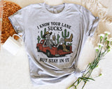 "I Know Your Lane Sucks Skeleton" design on a heather gray unisex t-shirt