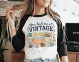 "You Had Me At Vintage Thrifting" design on a white baseball raglan tee with black sleeves