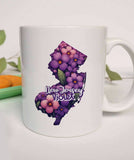 "New Jersey State Flower Violet" design on a white ceramic coffee mug