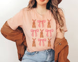 "Coquette Bunny" design on a peach unisex t-shirt
