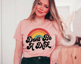 "Don't Be A D*ck Rainbow" design on a peach unisex t-shirt