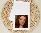 "Disgusted Doll Face Meme" design on a white 28 x 28 inch flour sack tea towel