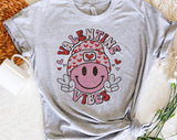 "Valentine Vibes Smiley Peace" design on a heather gray unisex t-shirt