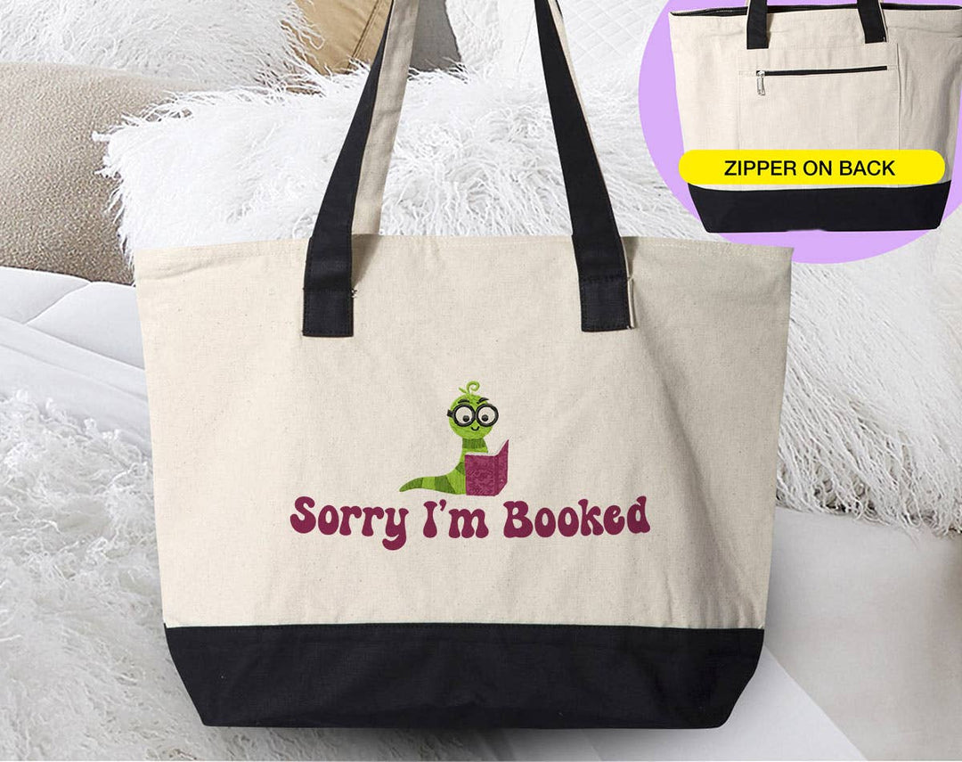 "Sorry I'm Booked" design on a natural canvas zippered tote bag