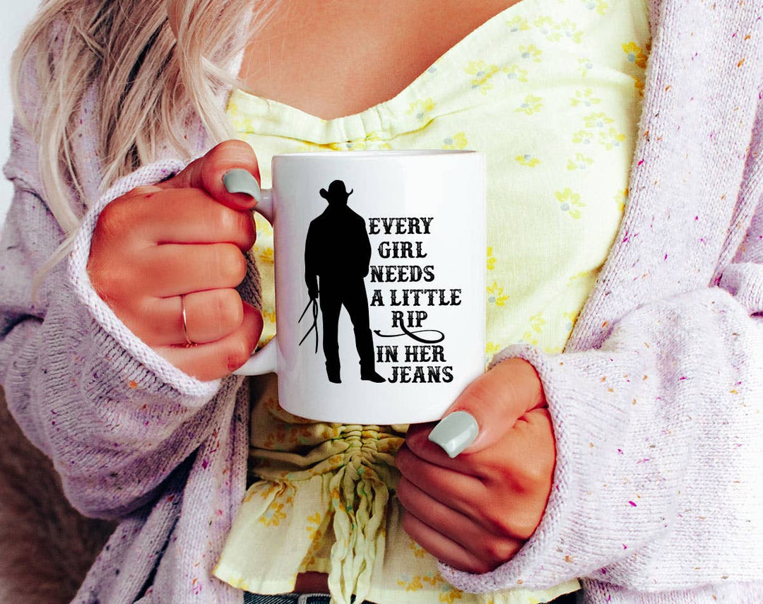 "Every Girl Needs Rip Jeans" design on a white ceramic coffee mug