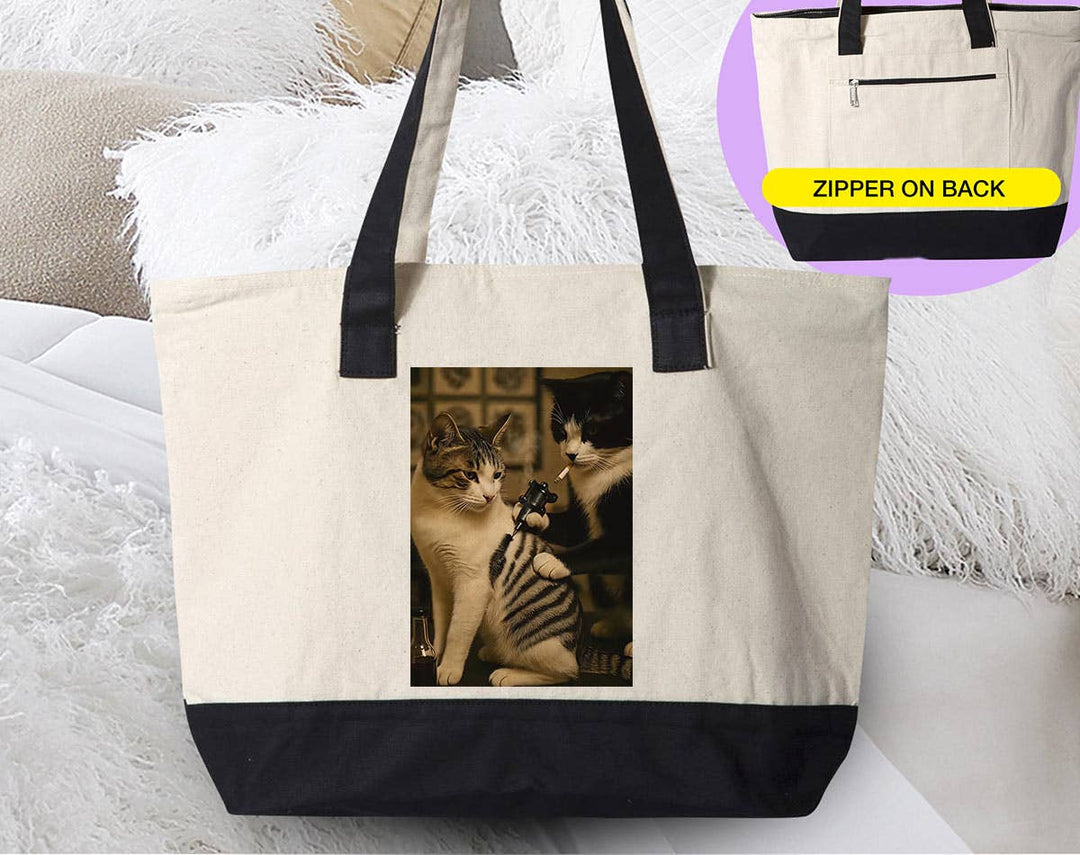 "Cat Getting Tattoo" design on a natural canvas zippered tote bag