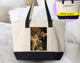 "Cat Getting Tattoo" design on a natural canvas zippered tote bag